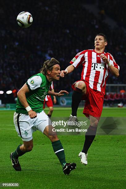 Clemens Fritz of Bremen and Bastian Schweinsteiger of Bayern battle for the ball during the DFB Cup final match between SV Werder Bremen and FC...