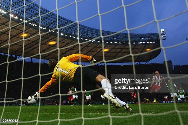 Arjen Robben of Bayern scores the opening goal through a penalty against Goalkeeper Tim Wiese of Bremen during the DFB Cup final match between SV...