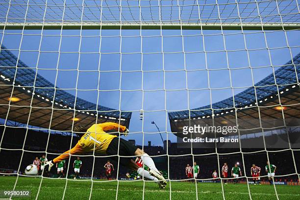 Arjen Robben of Bayern scores the opening goal through a penalty against Goalkeeper Tim Wiese of Bremen during the DFB Cup final match between SV...