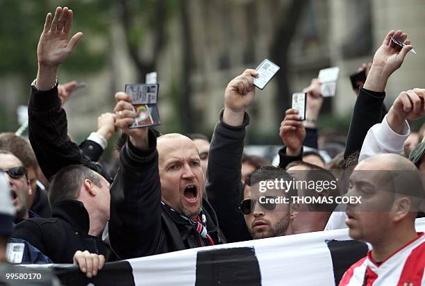 French members of the "Virage d'Auteuil" group of supporters of Paris Saint-Germain football club show their membersip cards during a demonstration...