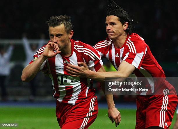 Ivica Olic of Bayern celebrates after scoring his team's second goal with team mate Daniel van Buyten during the DFB Cup final match between SV...