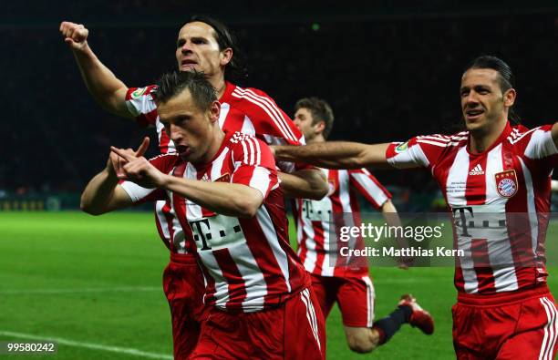 Ivica Olic of Bayern celebrates after scoring his team's second goal with team mates Daniel van Buyten and Martin Demichelis during the DFB Cup final...