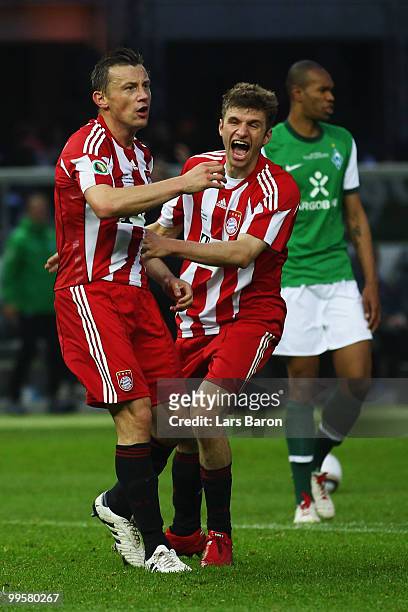 Ivica Olic and Thomas Mueller of Bayern celebrates after their team mate Arjen Robben scored the opening goal during the DFB Cup final match between...