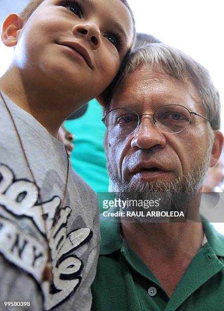 Colombian presidential candidate for the Green Party, Antanas Mockus, poses with a boy during a visit to the Commune 13 neighborhood in Medellin,...