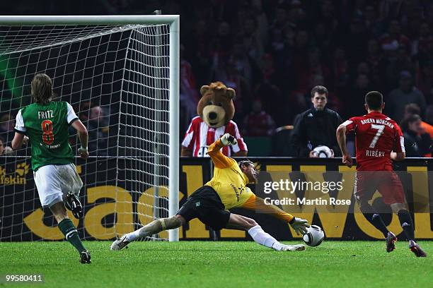 Franck Ribery of Bayern scores the third goal against goalkeeper Tim Wiese of Bremen during the DFB Cup final match between SV Werder Bremen and FC...