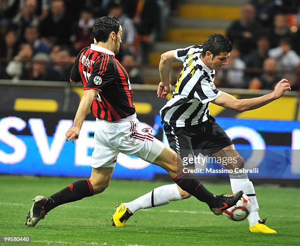 Gianluca Zambrotta of AC Milan tackles Vincenzo Iaquinta of Juventus FC during the Serie A match between AC Milan and Juventus FC at Stadio Giuseppe...