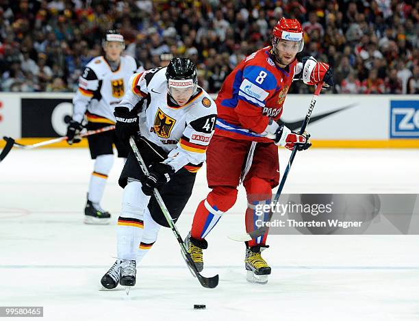 Christoph Ullmann of Germany battles for the puck with Alexander Ovechkin of Russia during the IIHF World Championship qualification round match...