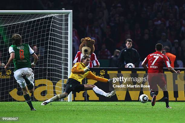 Franck Ribery of Bayern scores the third goal against goalkeeper Tim Wiese of Bremen during the DFB Cup final match between SV Werder Bremen and FC...