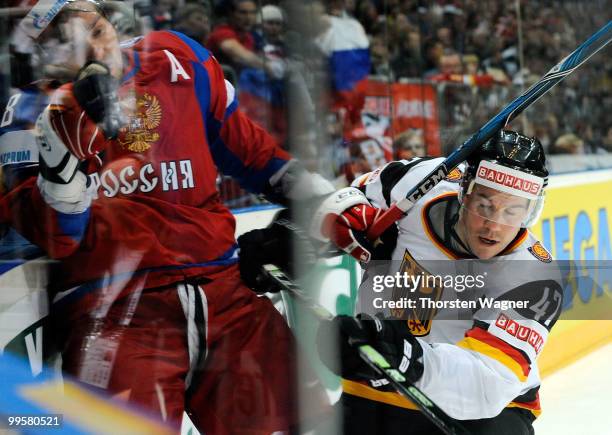 Christoph Ullmann of Germany battles for the puck with Alexander Ovechkin of Russia during the IIHF World Championship qualification round match...