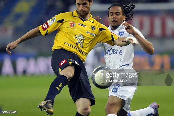 Sochaux' defender Jeremie Brechet fights for the ball with Auxerre's French forward Roy Contout during the French L1 football match Sochaux vs...