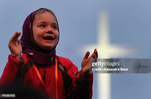 Young girl applauds during a concert of German singer Nena at the fourth day of the 2nd ecumenical Kirchentag on May 15, 2010 in Munich, Germany.