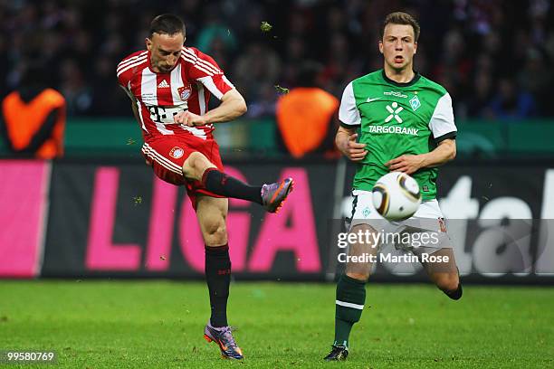 Franck Ribery of Bayern shoots at goal while Philipp Bargfrede of Bremen looks on during the DFB Cup final match between SV Werder Bremen and FC...