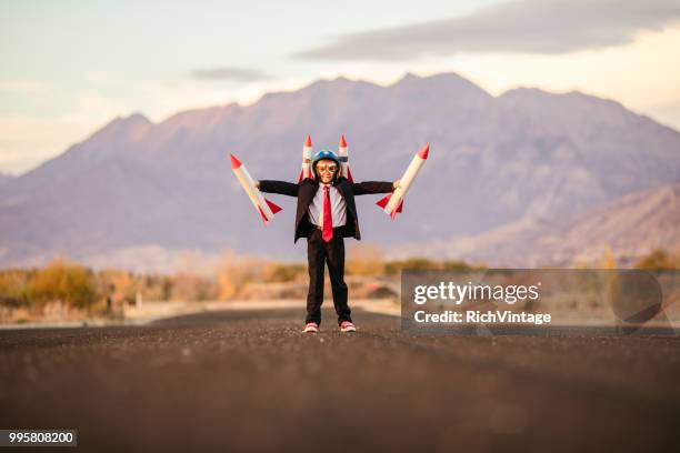 young business boy with rocket helmet and rockets - adult imitation stock pictures, royalty-free photos & images
