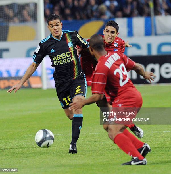 Marseille's foward Hatem Ben Arfa figths for the ball with the Grenoble's defender Jimmy Mainfroi during the French L1 football match Marseille vs...