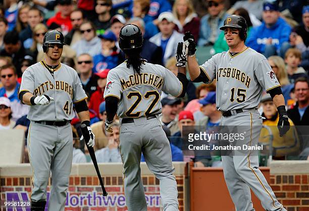 Ryan Doumit and Andy LaRoche of the Pittsburgh Pirates greet teammate Andrew McCutchen after McCutchen scored a run in the 1st inning against the...