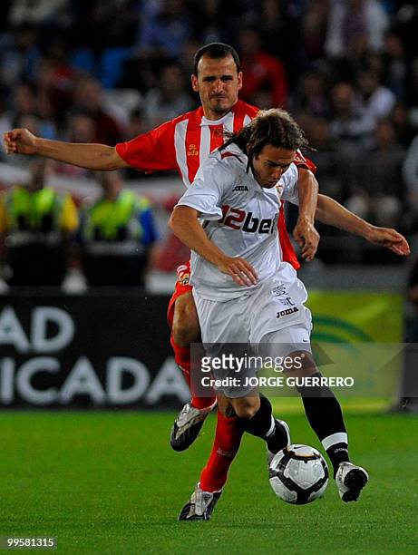 Sevilla's midfielder Diego Capel vies for the ball with Almeria's midfielder Fernando Soriano during their Spanish league football match at Juegos...