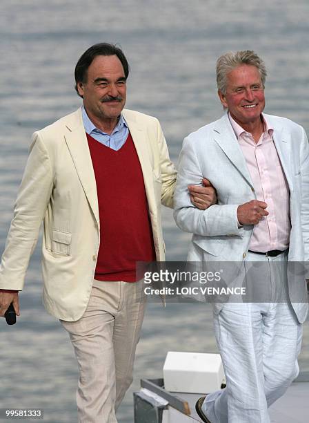 Film maker Oliver Stone and US actor Michael Douglas arrive to attend Canal Plus TV program "Le Grand Journal" on May 15, 2010 in Cannes, at the 63rd...