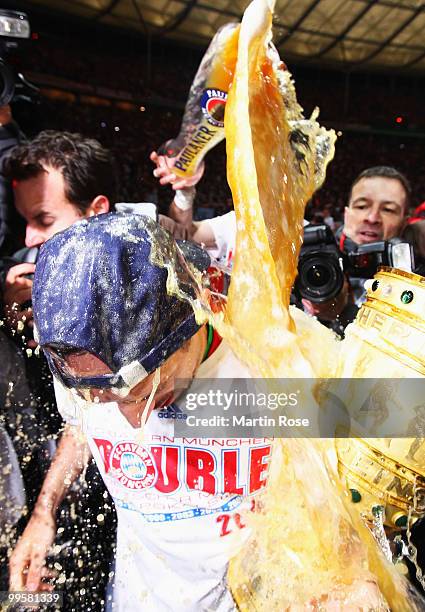 Franck Ribery of Bayern receives a beer shower after winning the DFB Cup final match between SV Werder Bremen and FC Bayern Muenchen at Olympic...