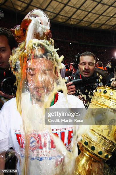 Franck Ribery of Bayern receives a beer shower after winning the DFB Cup final match between SV Werder Bremen and FC Bayern Muenchen at Olympic...