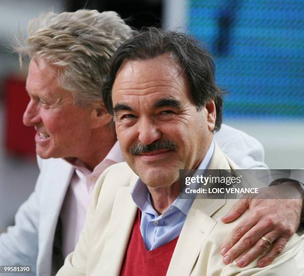 Film maker Oliver Stone and US actor Michael Douglas attend Canal Plus TV program "Le Grand Journal" on May 15, 2010 in Cannes, at the 63rd Cannes...