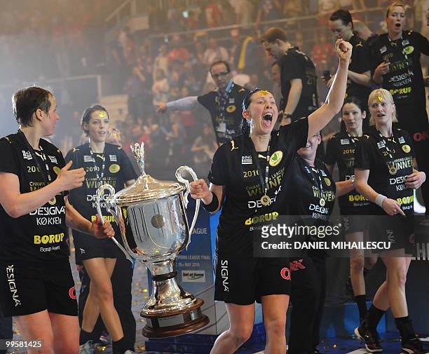Female members of the Viborg team celebrate their victory as they hold the EHF Champions League Trophy after they defeated Oltchim Ramnicu Valcea...