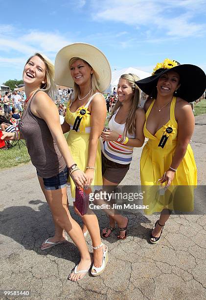 Race fans celebrate from the infield prior to the 135th running of the Preakness Stakes at Pimlico Race Course on May 15, 2010 in Baltimore, Maryland.