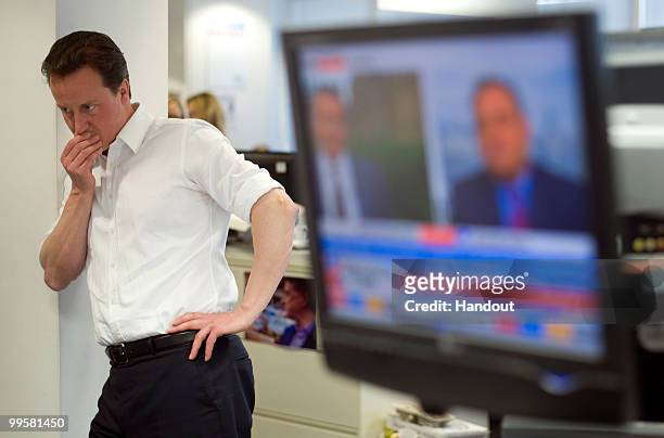 In this handout image provided by the Conservative Party, Leader of the Conservative Party David Cameron at CCHQ watches the election results come in...