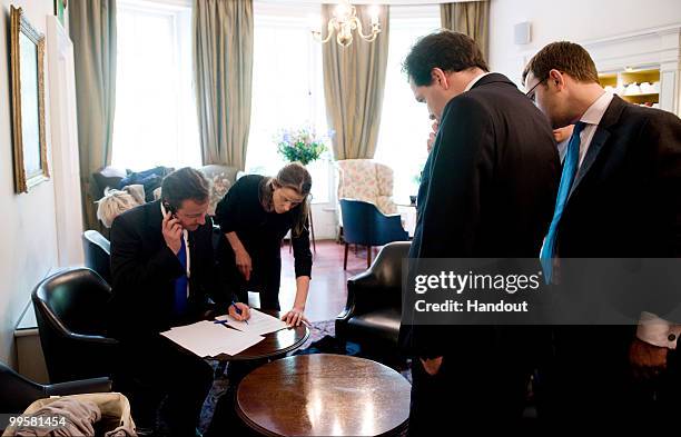 In this handout image provided by the Conservative Party, Leader of the Conservative Party David Cameron working on his statement with George Osborne...