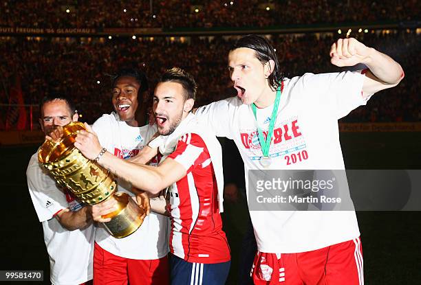 Franck Ribery, David Alaba, Diego Contento and Daniel van Buyten celebrate with the trophy after winning the DFB Cup final match between SV Werder...