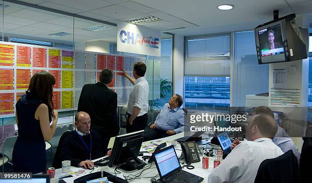 In this handout image provided by the Conservative Party, Leader of the Conservative Party David Cameron at CCHQ watching the election results come...
