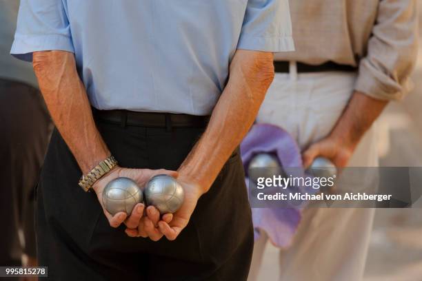hands of boules players - traditional sport stock pictures, royalty-free photos & images