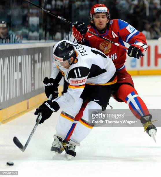 Sven Felski of Germany battles for the puck with Alexander Ovechkin of Russia during the IIHF World Championship qualification round match between...
