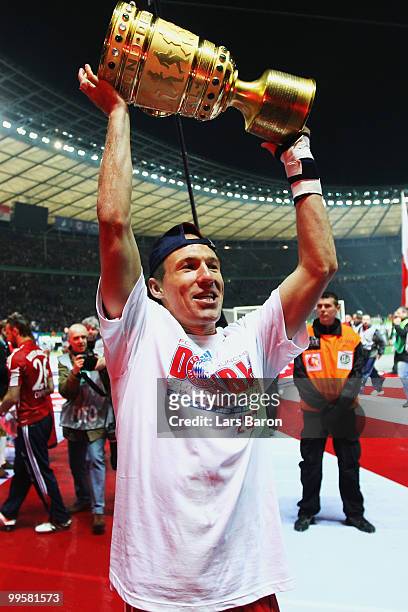Arjen Robben of Bayern Muenchen celebrates with the DFB Cup trophy following his team's victory at the end of the DFB Cup final match between SV...