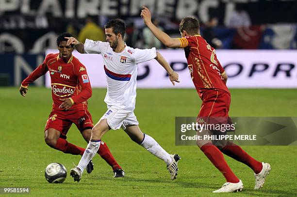 Lyon's Bosnian midfielder Miralem Pjanic vies with Le Mans' French midfielder Ludovic Baal and Le Mans' French midfielder Guillaume Loriot during the...