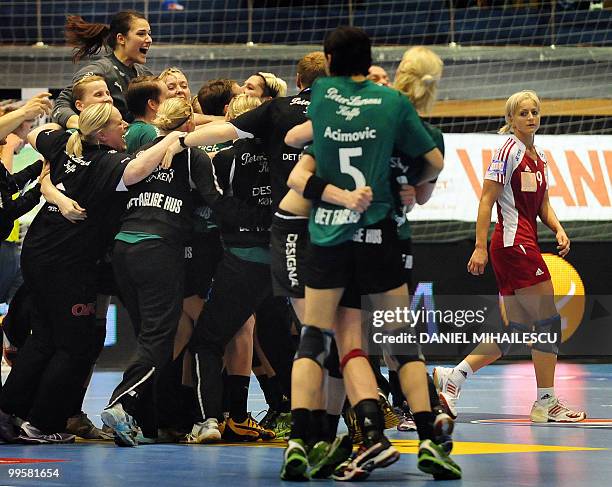 Female members of the Viborg team celebrate their victory after they defeated Oltchim Ramnicu Valcea as Stanca Ionela of Oltchim Ramnicu Valcea...