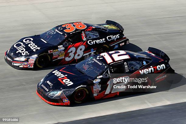 Kasey Kahne, driver of the Great Clips Toyota, and Justin Allgaier, driver of the Verizon Wireless Dodge, race side by side during the NASCAR...