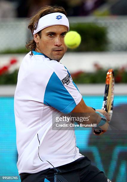 David Ferrer of Spain lines up to play a backhand against Roger Federer of Switzerland in their semi final match during the Mutua Madrilena Madrid...