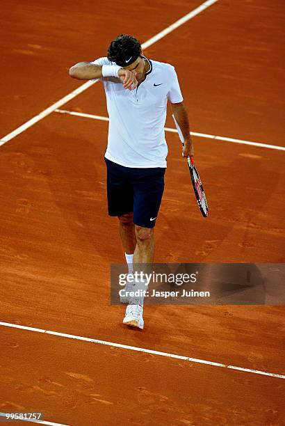 Roger Federer of Switzerland reacts in his semi-final match against David Ferrer of Spain during the Mutua Madrilena Madrid Open tennis tournament at...