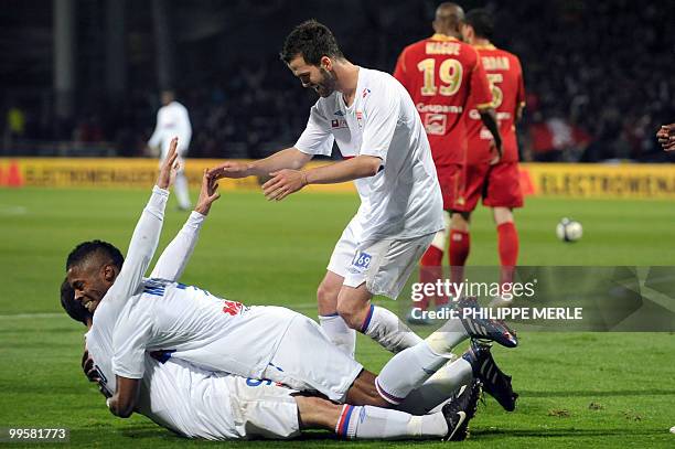 Lyon's Bosnian middfielder Miralem Pjanic is congratulated by teammates after scoring a goal during the French L1 football match Lyon vs Le Mans on...