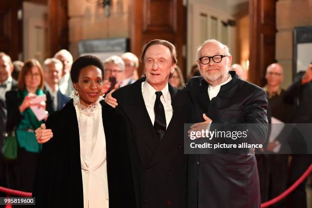 Musician Marius Mueller-Westernhagen and his wife Lindiwe Suttle are greeted by the director Juergen Flimm at the reopening of the Berliner...