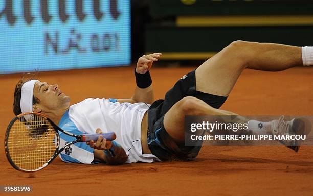Spanish David Ferrer falls during a semi-final match of the Madrid Masters against Swiss Roger Federer on May 15, 2010 at the Caja Magic sports...