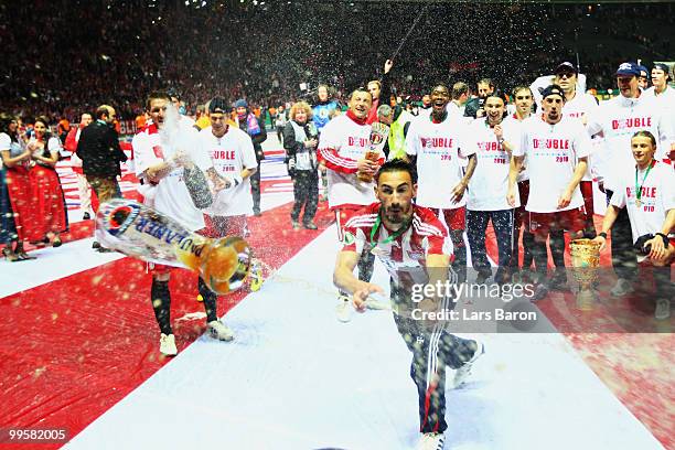 Diego Contento of Bayern Muenchen throws a beer glas following his team's victory at the end of the DFB Cup final match between SV Werder Bremen and...