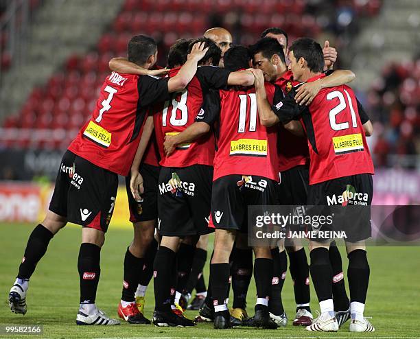 Mallorca's players celebrate after scoring against Espanyol during their Spanish League football match at the Ono Stadium in Palma de Mallorca, on...