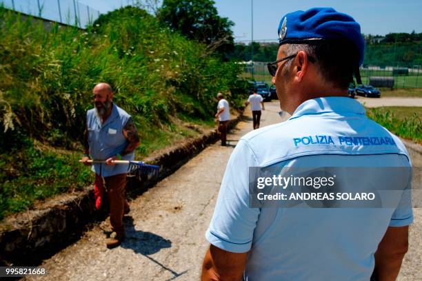 Inmates of the Rebibbia prison, work using garden tools, sharp implements, shears and trimmers, under the supervision of the prison guard, as part of...