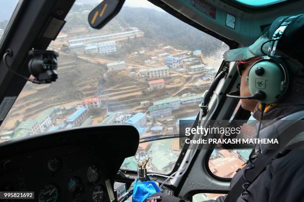 In this photograph taken on April 28 a helicopter flies over Namche Bazar, along the route to reach Everest Base Camp.