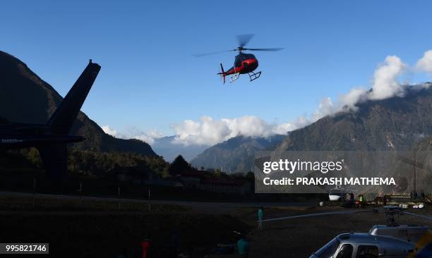 In this photograph taken on April 13 a helicopter flies over Lukla airport, along the route to reach Everest Base Camp.