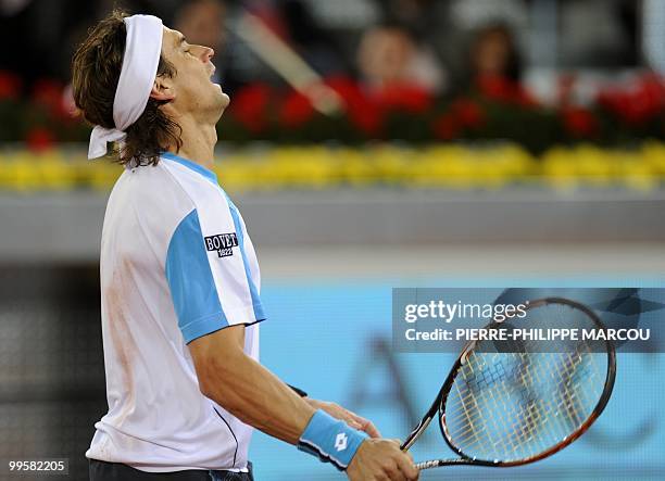 Spanish David Ferrer gestures during a semi-final match of the Madrid Masters against Swiss Roger Federer on May 15, 2010 at the Caja Magic sports...