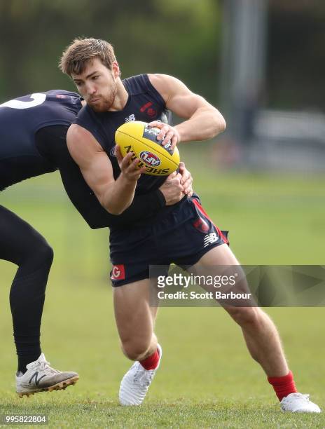 Jack Viney of the Demons is tackled by Nathan Jones of the Demons during a Melbourne Demons AFL training session at Gosch's Paddock on July 11, 2018...