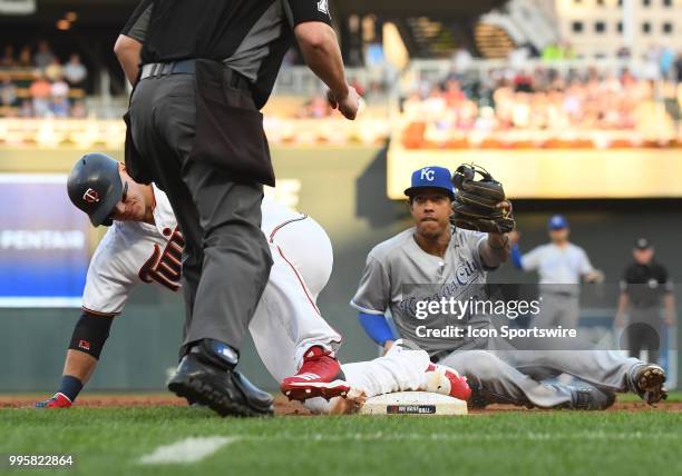 Minnesota Twins Designated hitter Logan Morrison is tagged out by Kansas City Royals Shortstop Adalberto Mondesi after trying to stretch a double...