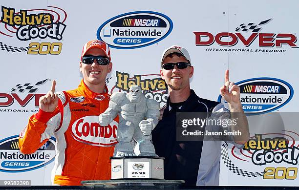 Kyle Busch , driver of the Combos Toyota, poses with crew chief Jason Ratcliff in victory lane after winning the NASCAR Nationwide Series Heluva...